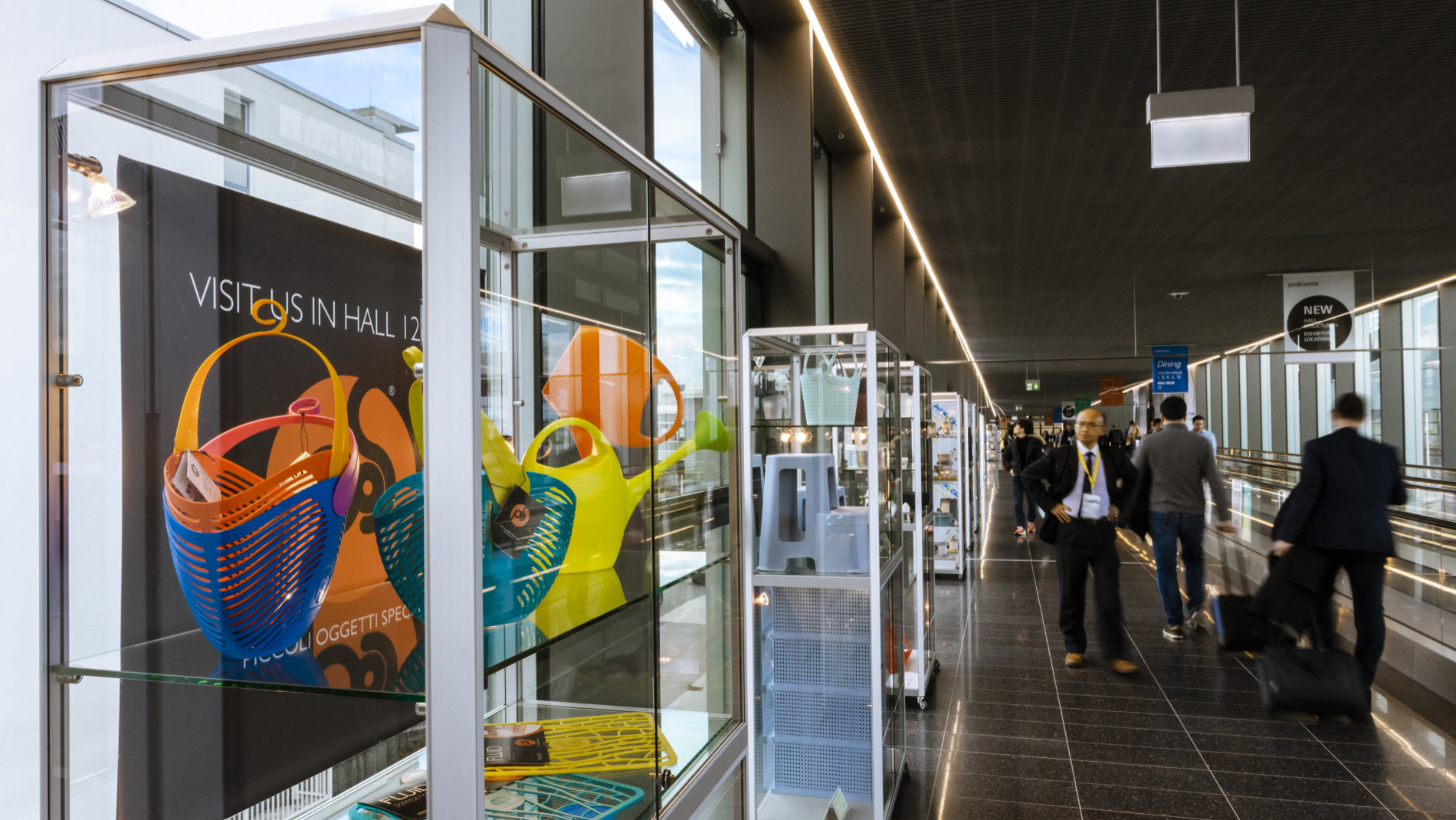 Visitors walk past a showcase on the exhibition grounds