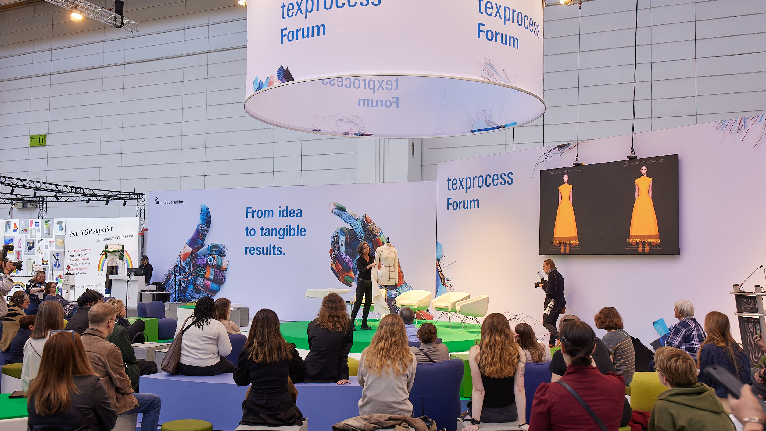 Visitors watch a live demonstration at the Texprocess Forum